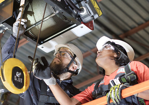 Konecranes technicians inspect a hoist